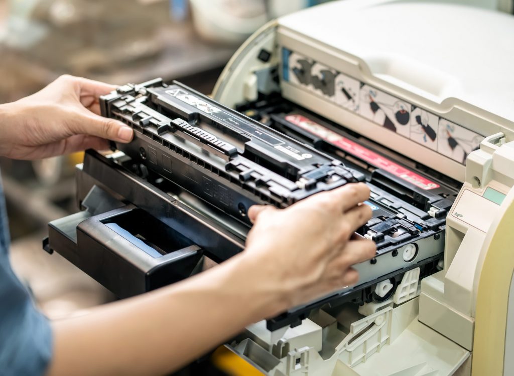 Women holding Laser toner cartridge ,replacing toner in laser printer at office. Repairs and Maintenance Laser printers concept